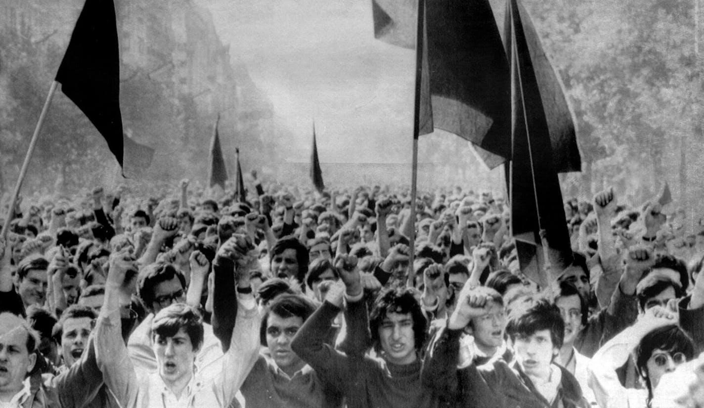 June 2, 1968 Students carried red and black flags at Demonstration in Paris Saturday - They massed on the Left Bank to show opposition to French President Charles de Gaulle - Tens of thousands of students and workers demonstrated against President Charles de Gaulle here Saturday, while pro-Gaullist students in Strasbourg stormed the leftist-occupied university there in an attempt to pull down a red flag. The Paris demonstrators urged millions of French strikers to stay off work. A timid back-to-