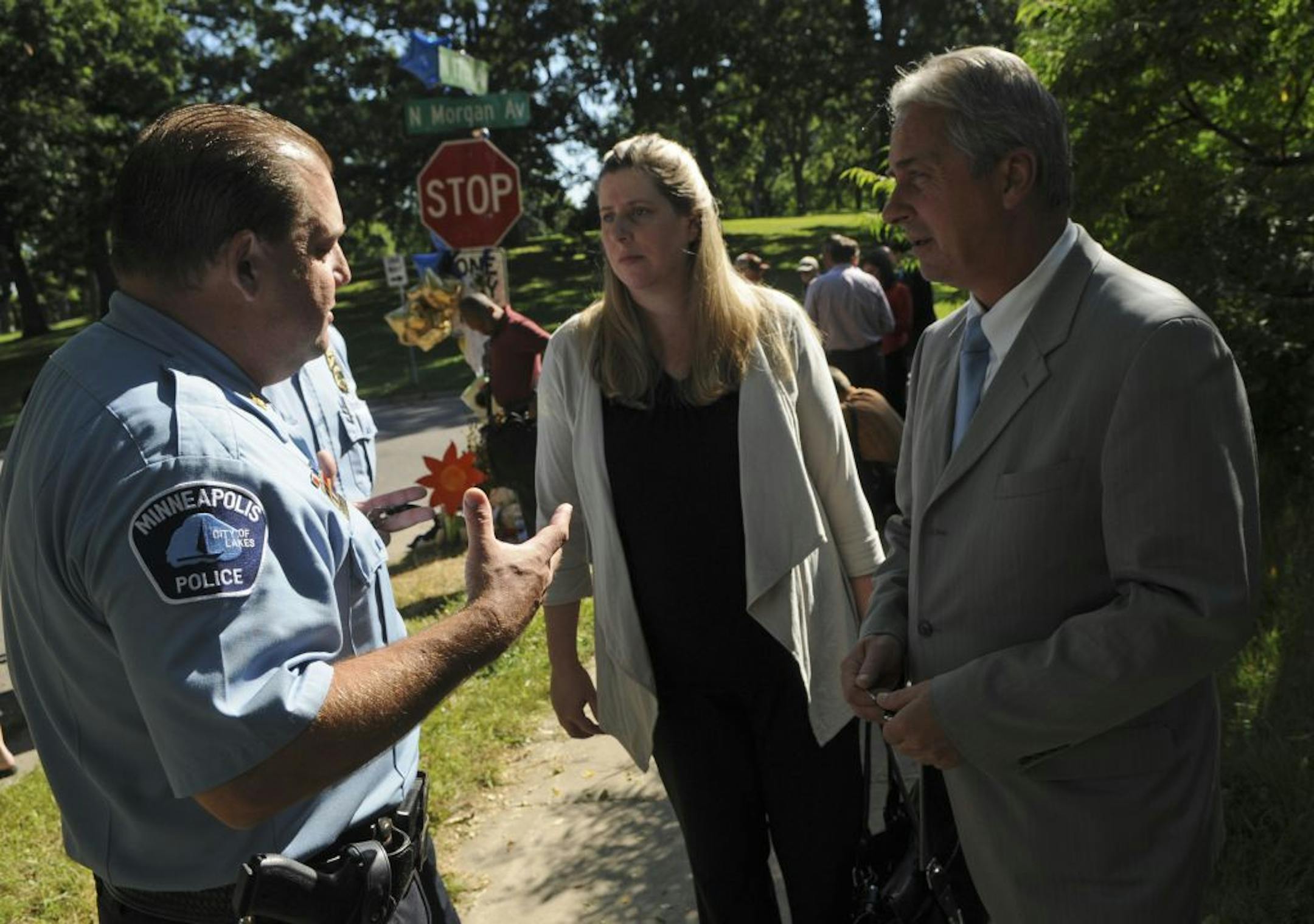 Inspector Mike Martin talked with Lts. Amelia Huffman and Rick Zimmerman after a news conference on the North Side.