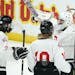 Gentry Academy goaltender Alex Timmons (32) celebrated with forward Reese Shaw (7) and defenseman Zach Reim (10) after beating East Grand Forks at the