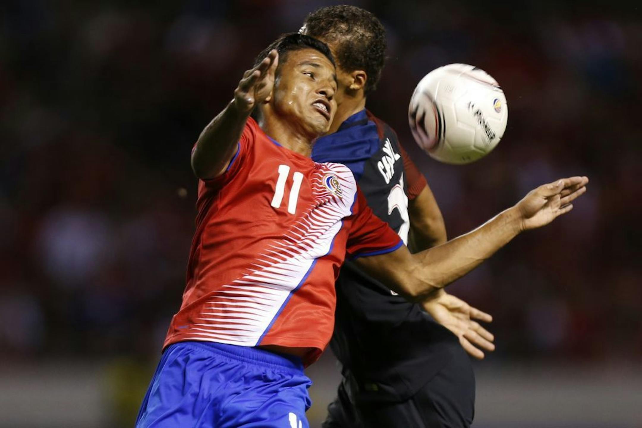 Costa Rica's Johan Venegas (11) fights for the ball against United States' Timothy Chandler during a 2018 World Cup qualifying soccer match in San Jose, Costa Rica, Tuesday, Nov. 15, 2016.