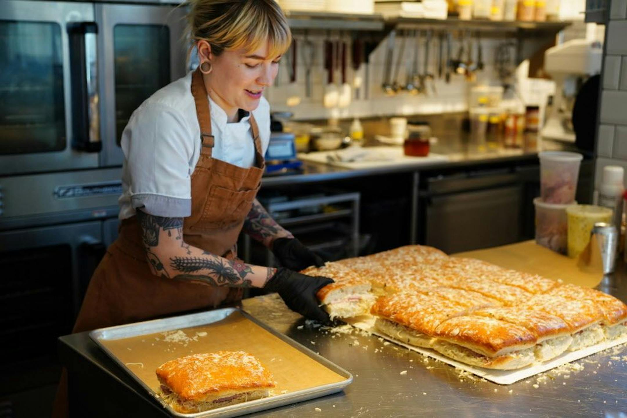 Sous chef Jasmine Weiser reapers some ham and gruyere panini.