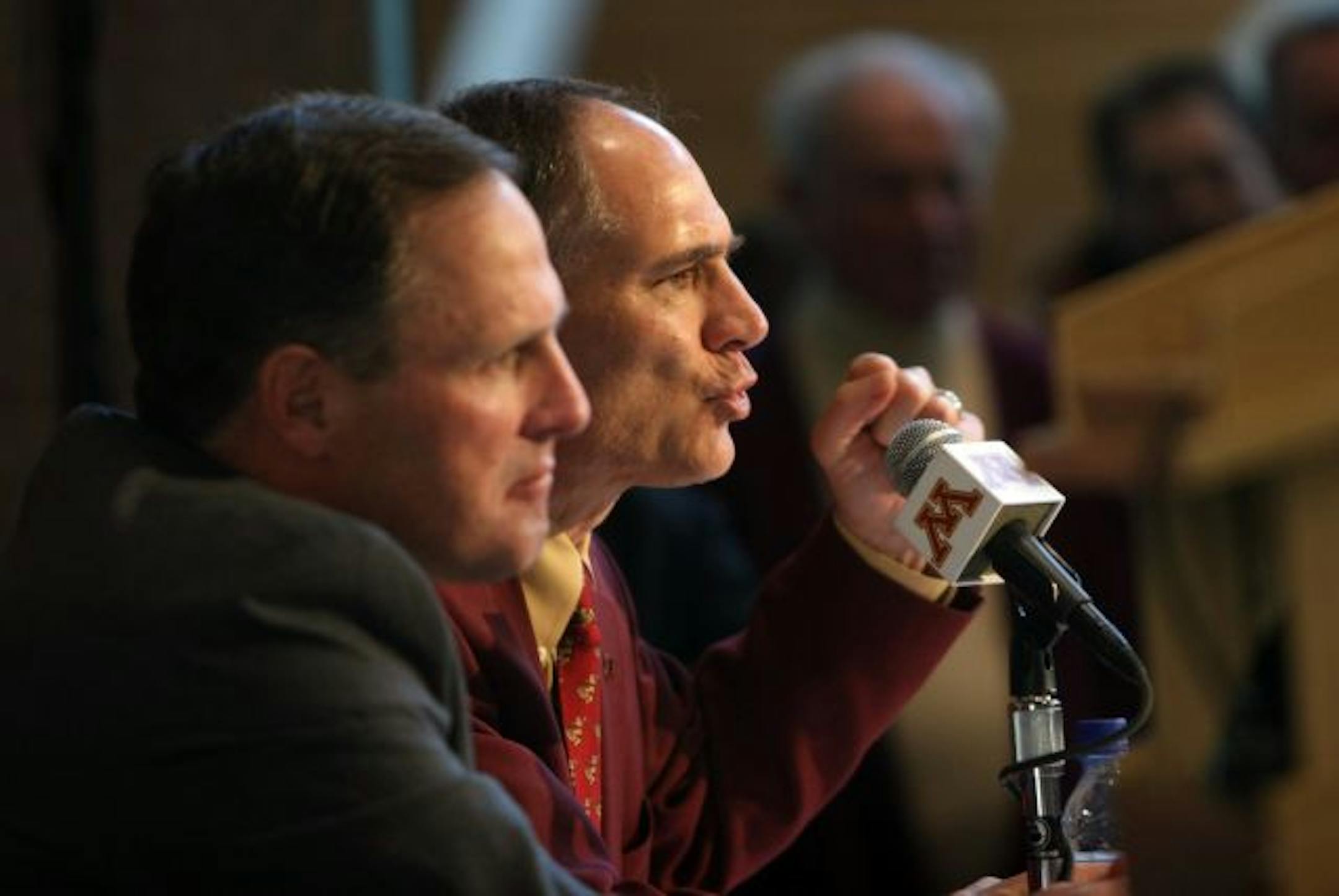Both Tim Brewster, left, and the man that hired him, Joel Maturi, should be relieved of their duties. If a big-time AD isn't hired, then a search committee should pick the new coach.