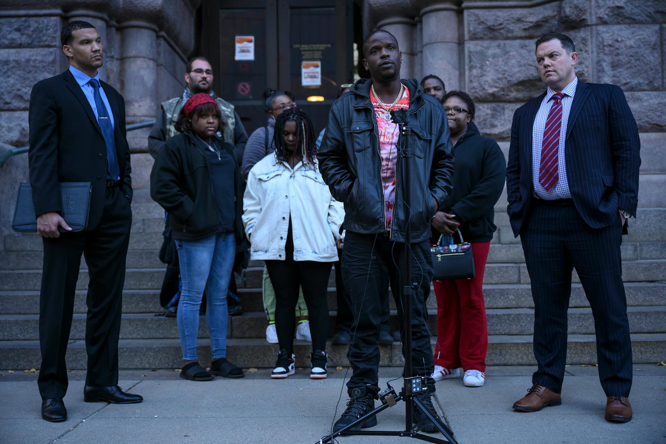 Orlando Frazier, brother of Leneal Frazier, speaks about Leneal's death and the court appearance of Minneapolis Police officer Brian Cummings during a news conference outside Minneapolis City Hall Tuesday, Nov. 9, 2021 in Minneapolis, Minn. Standing with Frazier is his family and attorneys Jeff Storms, right, and Christopher Scott. Minneapolis police officer Brian Cummings made his first appearance in court via zoom Tuesday for striking a vehicle and killing the driver, Leneal Frazier, during a pursuit through in July, 2021. ] AARON LAVINSKY • aaron.lavinsky@startribune.com