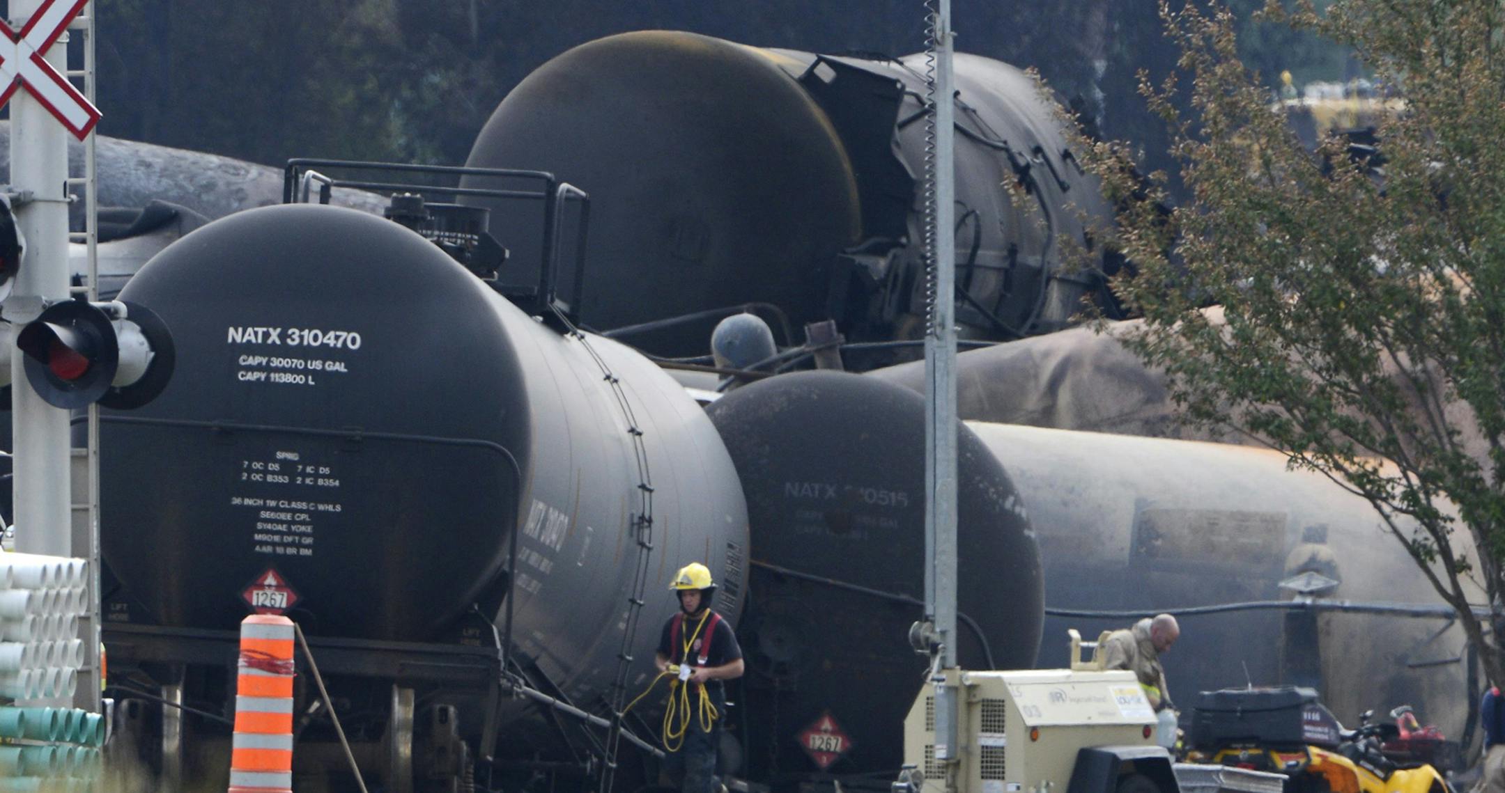 Cleanup continues at the scene of the Lac-Megantic, Quebec, runaway oil train derailment and explosion, Tuesday, July 9, 2013. Investigators looking for the cause of the fiery oil train derailment are zeroing in on whether an earlier blaze on the same train may have set off a chain of events that led to the explosions that killed at least 13 people.
