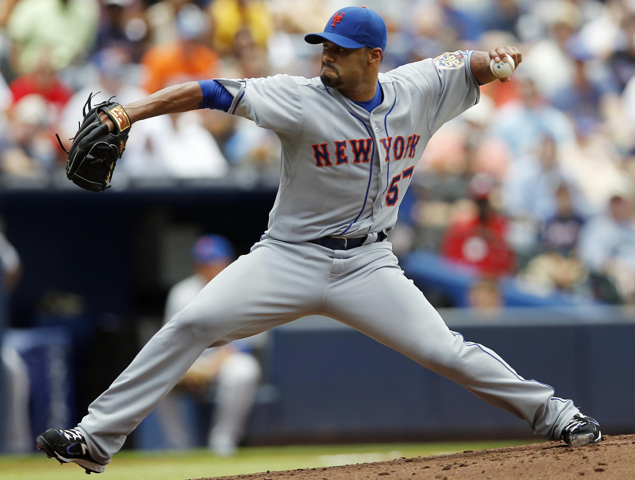 FILE - In this Juy 15, 2012, file photo, New York Mets starting pitcher Johan Santana works in a baseball game against the Atlanta Braves in Atlanta. The Toronto Blue Jays have signed two-time Cy Young winner Santana to a minor league contract, hoping the former ace can make it back to the majors. The Blue Jays announced the deal Thursday, Feb. 26, 2015, and invited him to big league spring training. (AP Photo/John Bazemore, File) ORG XMIT: MIN2015022620530471