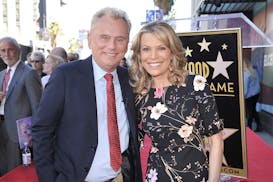 FILE - Pat Sajak, left, and Vanna White, from "Wheel of Fortune," attend a ceremony honoring Harry Friedman with a star on the Hollywood Walk of Fame 