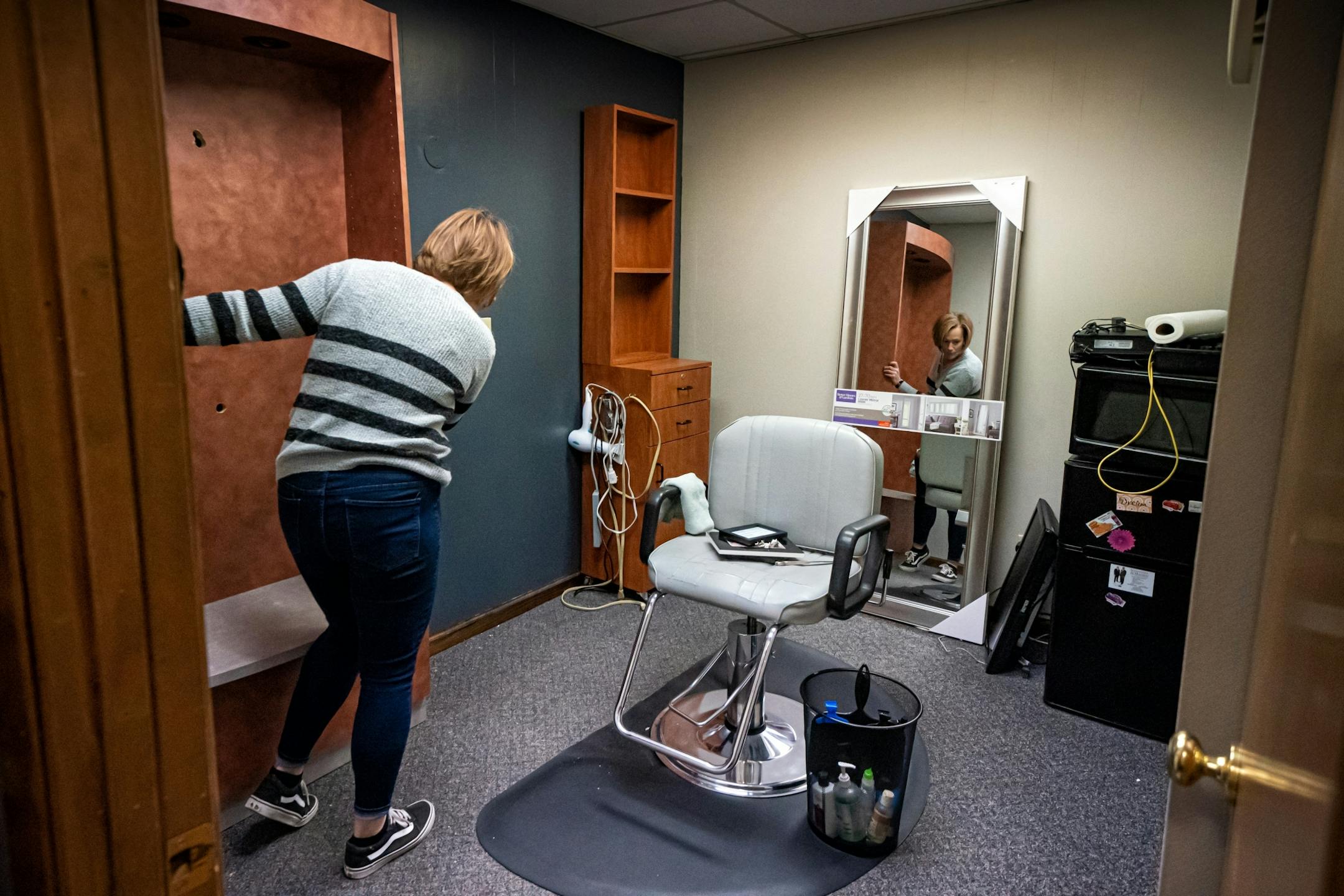 Leah Watzke, owner of Hair Lounge on Main Street, Hutchinson, is preparing to reopen by putting stylists in separate rooms, moving chairs farther apart and removing magazines that customers might be tempted to share.