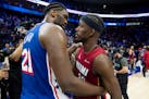 The 76ers' Joel Embiid, left, talks with the Heat's Jimmy Butler after host Philadelphia won the teams' NBA play-in game 105-104 on Wednesday night.