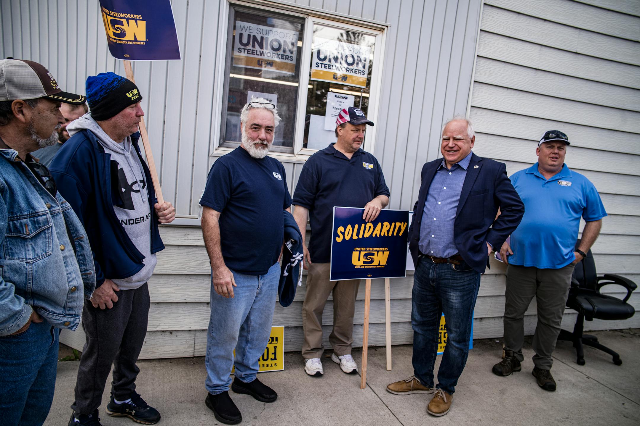 Governor Tim Walz talks with Local 2660 steelworks, who are negotiating a new contract, after attending  an event celebrating US Steel's investment in a $150 million DR grade pellet plant in Keewatin.