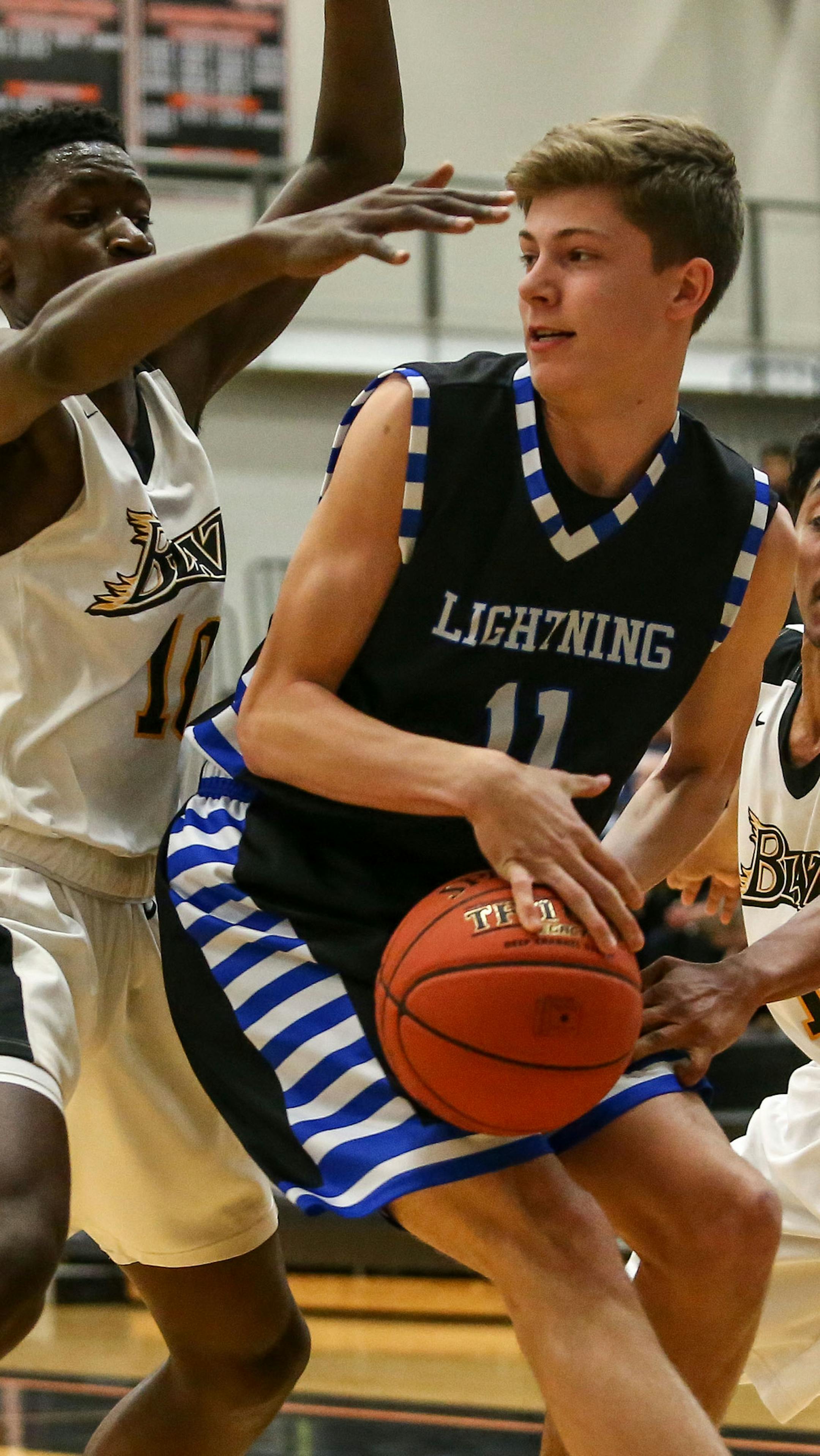 Jackson Purcell (11) is trapped in the corner by Cedric Ung (10) and Julian Quiroz-Hutchinson (1) forcing a jump ball. Eastview leads Burnsville at halftime by a score of 33-27 at Farmington High School. Photo by Cheryl Myers, SportsEngine