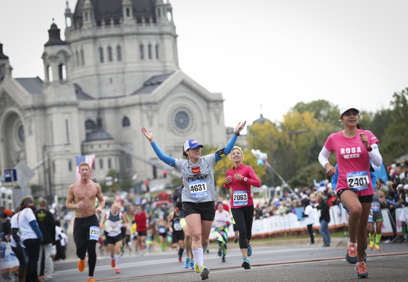 Molly Bohrer raised her arms as she approached the finish line of the 2014 Twin Cities Marathon in St. Paul.