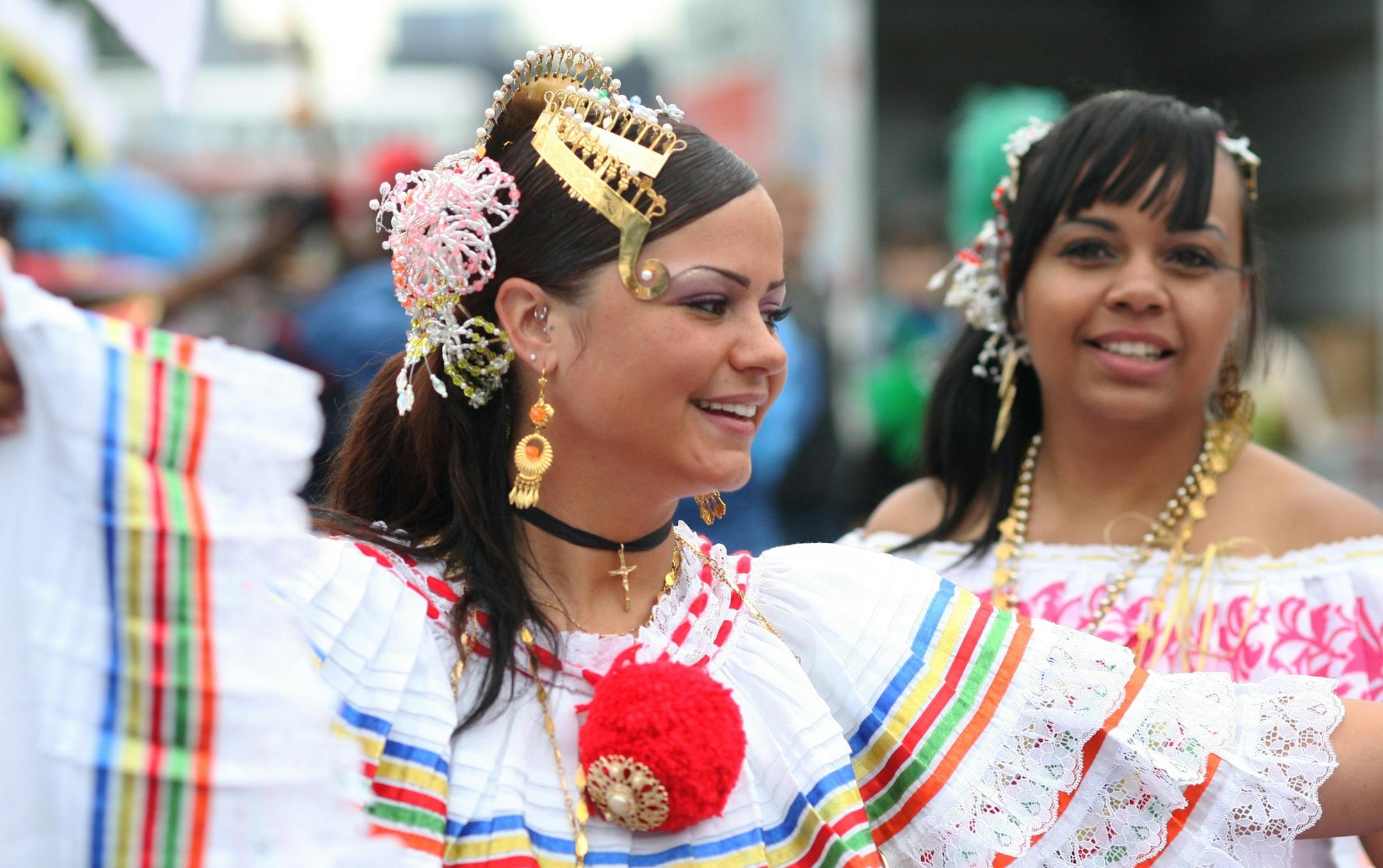 Panamanian-American performer Tina Campbell, foreground, marches in the 20th annual Carifest carnival held July 27, 2013, along the riverfront in Minneapolis.