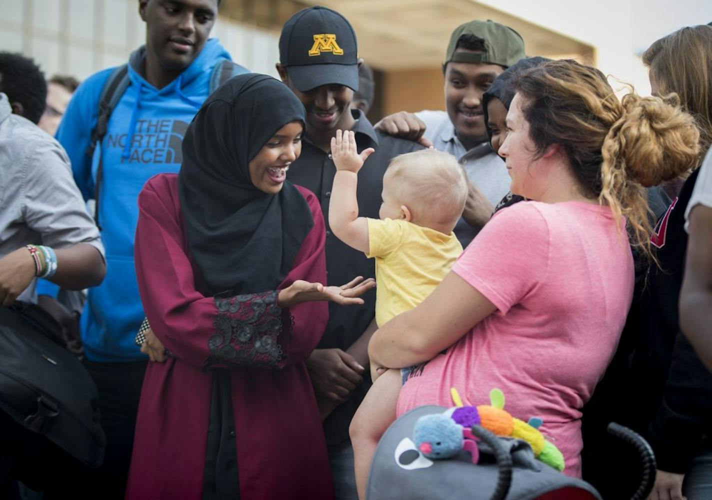 Halima Aden gave some attention to Jayse Waisanen, who kept touching her out of curiosity as his mother, Daynelle Hoff, held him Tuesday during a unity rally at St. Cloud State University.