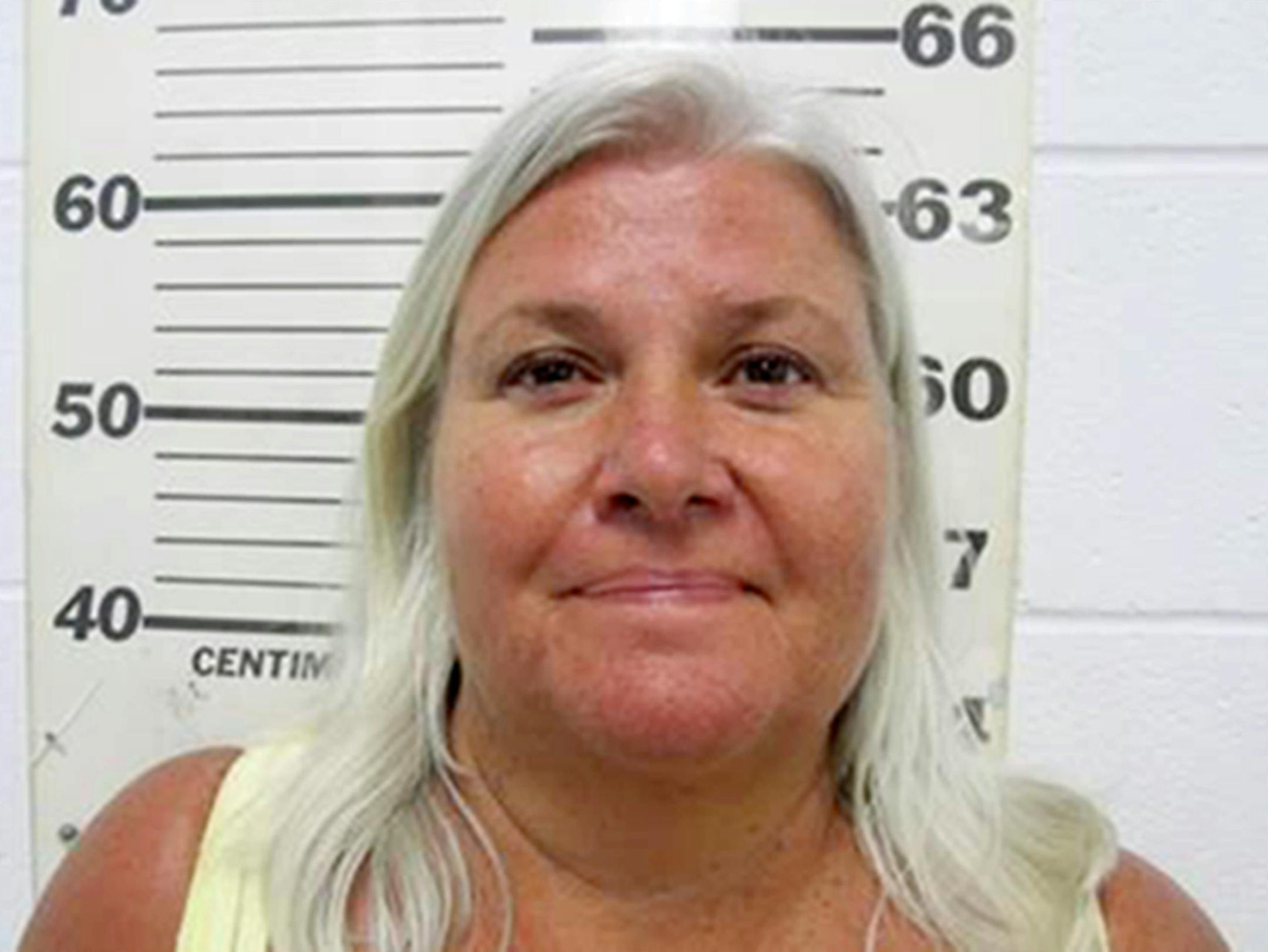 This photo provided by the South Padre Island Police Department shows Lois Riess, of Blooming Prairie, Minn., who was arrested by federal deputy marshals Thursday, April 19, 2018, at a restaurant in South Padre Island, Texas. Investigators believe she killed her husband in Minnesota then fled to Florida where she used the same gun to slay her doppelganger with the intention of assuming her identity. Riess had been on the run since at least late March. (South Padre Island Police Department via AP
