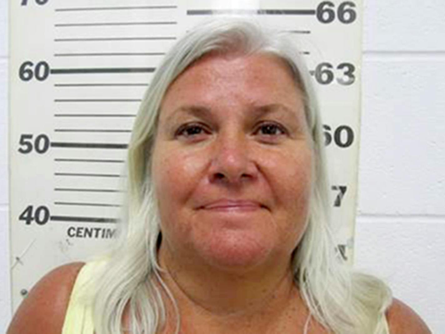 This photo provided by the South Padre Island Police Department shows Lois Riess, of Blooming Prairie, Minn., who was arrested by federal deputy marshals Thursday, April 19, 2018, at a restaurant in South Padre Island, Texas. Investigators believe she killed her husband in Minnesota then fled to Florida where she used the same gun to slay her doppelganger with the intention of assuming her identity. Riess had been on the run since at least late March. (South Padre Island Police Department via AP