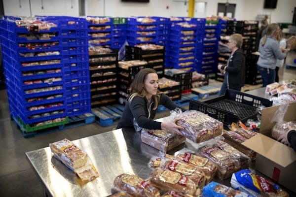 Volunteer Kimberly Lawrence of Rosemount packed loaves of bread at Second Harvest Heartland, the state's largest food bank. Staffers and volunteers wi