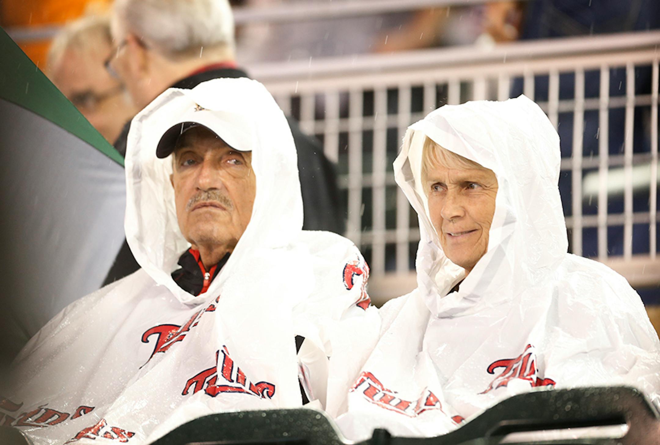 Fans sits in the stands during a rain delay ealier this season.