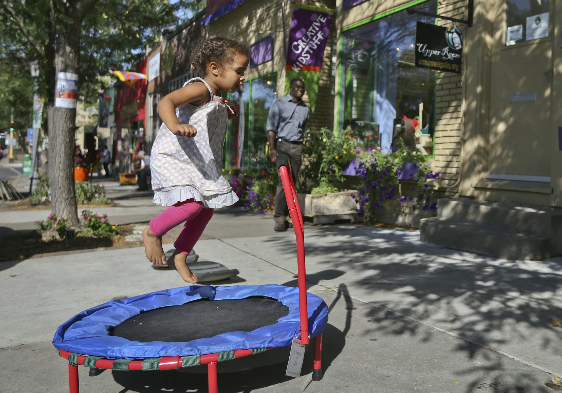 Madeline Ketcham watched her three-year-old daughter Suna jump on a trampoline outside Creative Kidstuff at 43rd and Upton Avenue in the linden Hill neighborhood of Minneapolis, Minn., on Wednesday, September 10, 2013. ] (RENEE JONES SCHNEIDER • reneejones@startribune.com)