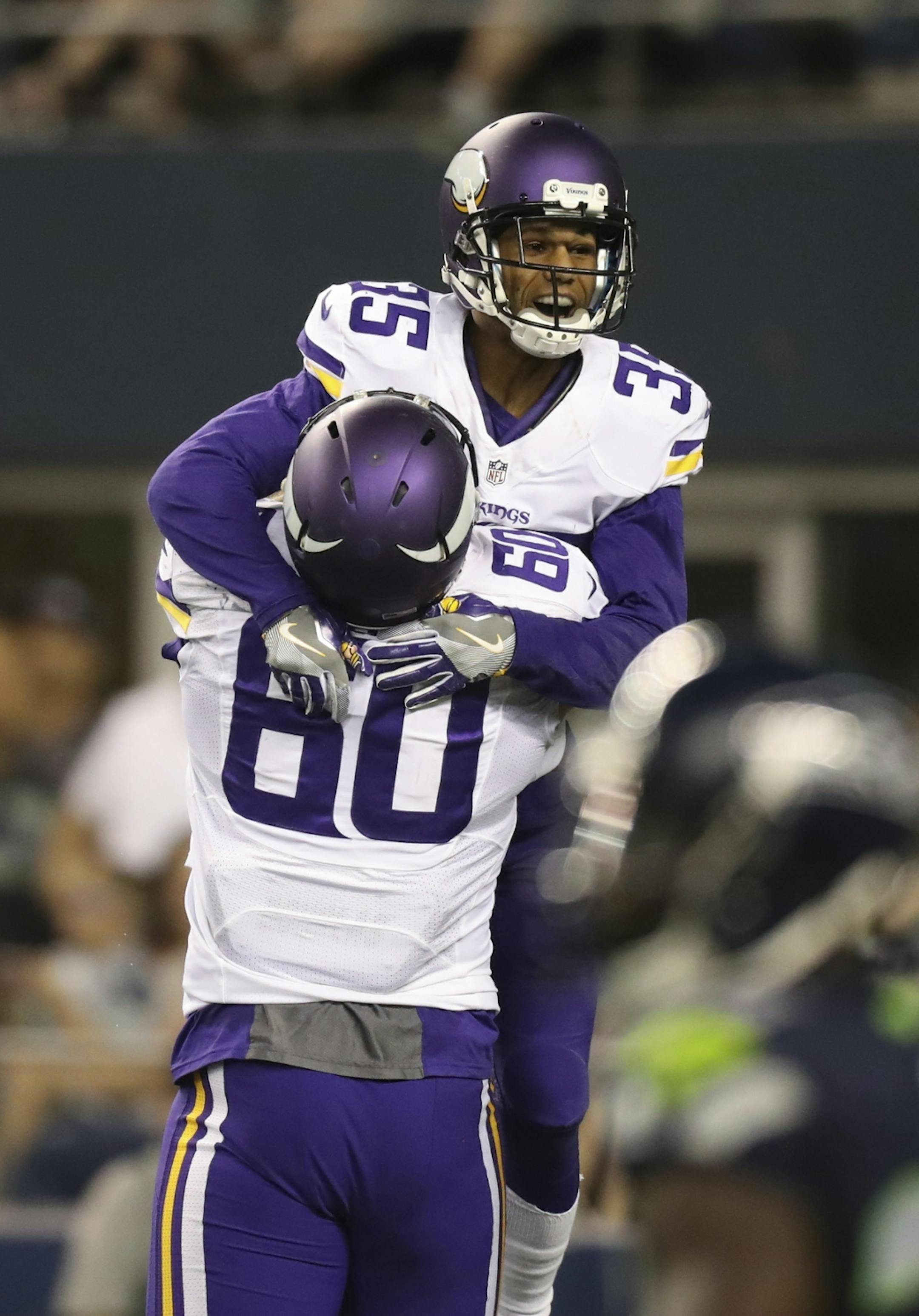 Vikings cornerback Marcus Sherels (35) was hoisted aloft by Vikings tackle Carter Bykowski (60) as they celebrated his fourth quarter pass interception that he returned for 53 yards and the game winning touchdown Thursday night.