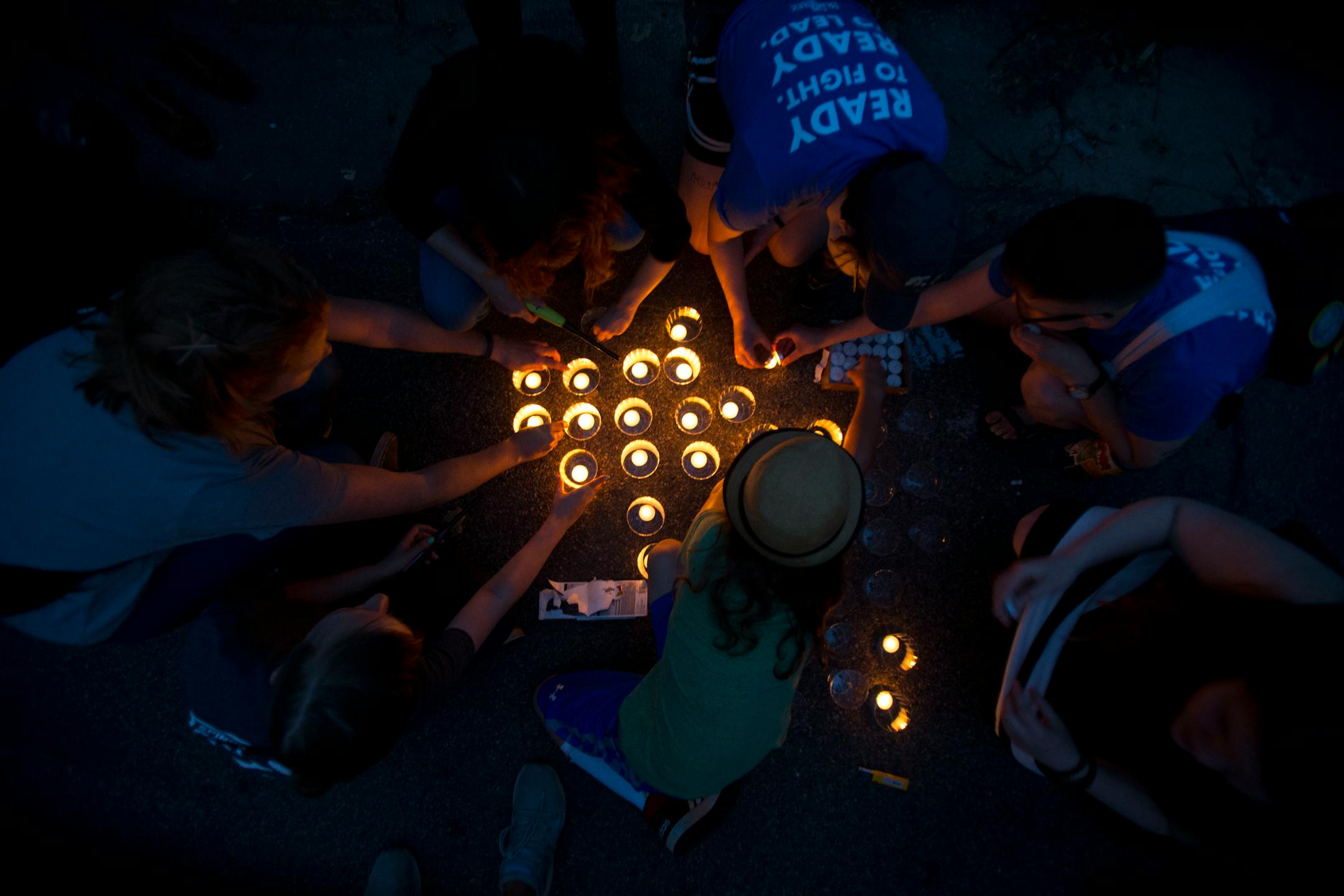 Community members work together to light candles to be passed out to those in attendance at the vigil. ] ALEX KORMANN � alex.kormann@startribune.com Dozens of local community members, family of Thurman Belvins and activists gathered at the corner of 48th street and Camden Ave on Sunday evening for a candle lit vigil to remember the life of Belvins who died Saturday. Belvins was shot by police starting on that same corner Saturday afternoon. Community members expressed anger, frustration, pain an