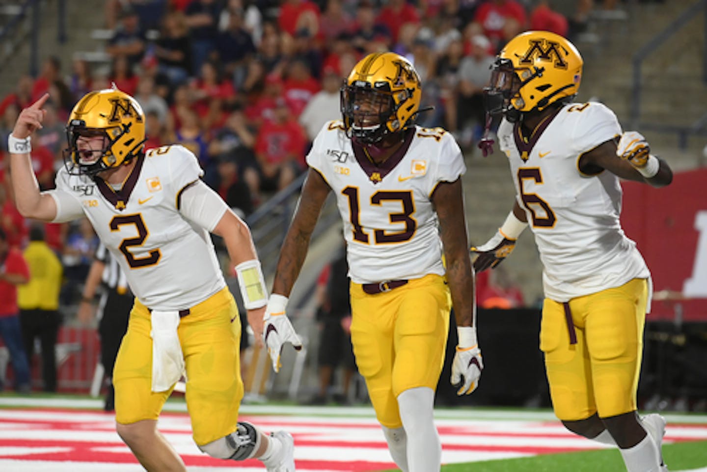 Gophers quarterback Tanner Morgan, wide receiver Rashod Bateman (13) and wide receiver Tyler Johnson (6) celebrated after a touchdown by Bateman on the opening drive of the first quarter against the Fresno State Bulldogs.