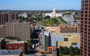 The Minnesota State Capitol is visible from rooftops of downtown St. Paul. State workers are returning to their offices this week.