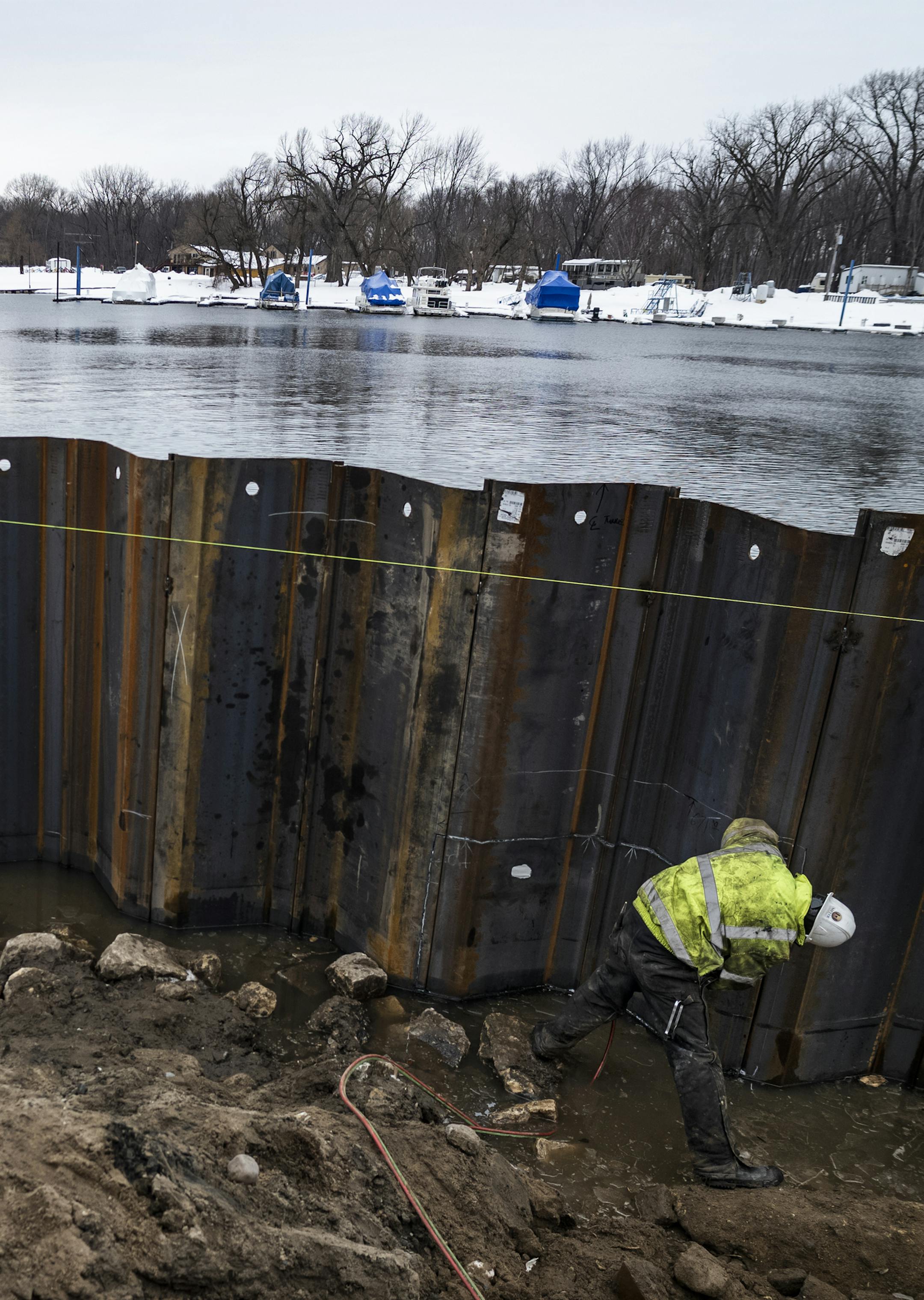 Workers including Greg Dervie on the Levee Park project are putting in longer shifts to add sheet piling on the water front area. The buoys are to control spills from the construction zone. ] In an effort to get ahead of any possible flooding, extra work crews have been added to the Hwy 63 bridge construction project from Red Wing to Wisconsin, and workers on the Levee Park project are working longer shifts to add sheet piling. RICHARD TSONG-TAATARII &#xa5; richard.tsong-taatarii@startribune.com