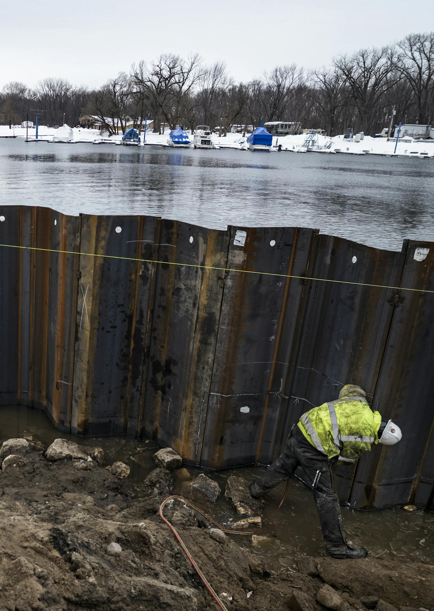 Workers including Greg Dervie on the Levee Park project are putting in longer shifts to add sheet piling on the water front area. The buoys are to control spills from the construction zone. ] In an effort to get ahead of any possible flooding, extra work crews have been added to the Hwy 63 bridge construction project from Red Wing to Wisconsin, and workers on the Levee Park project are working longer shifts to add sheet piling. RICHARD TSONG-TAATARII &#xa5; richard.tsong-taatarii@startribune.com