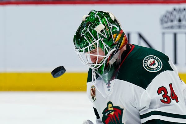 Wild goaltender Kaapo Kahkonen makes a heads-up save against the Arizona Coyotes during the second period Friday.