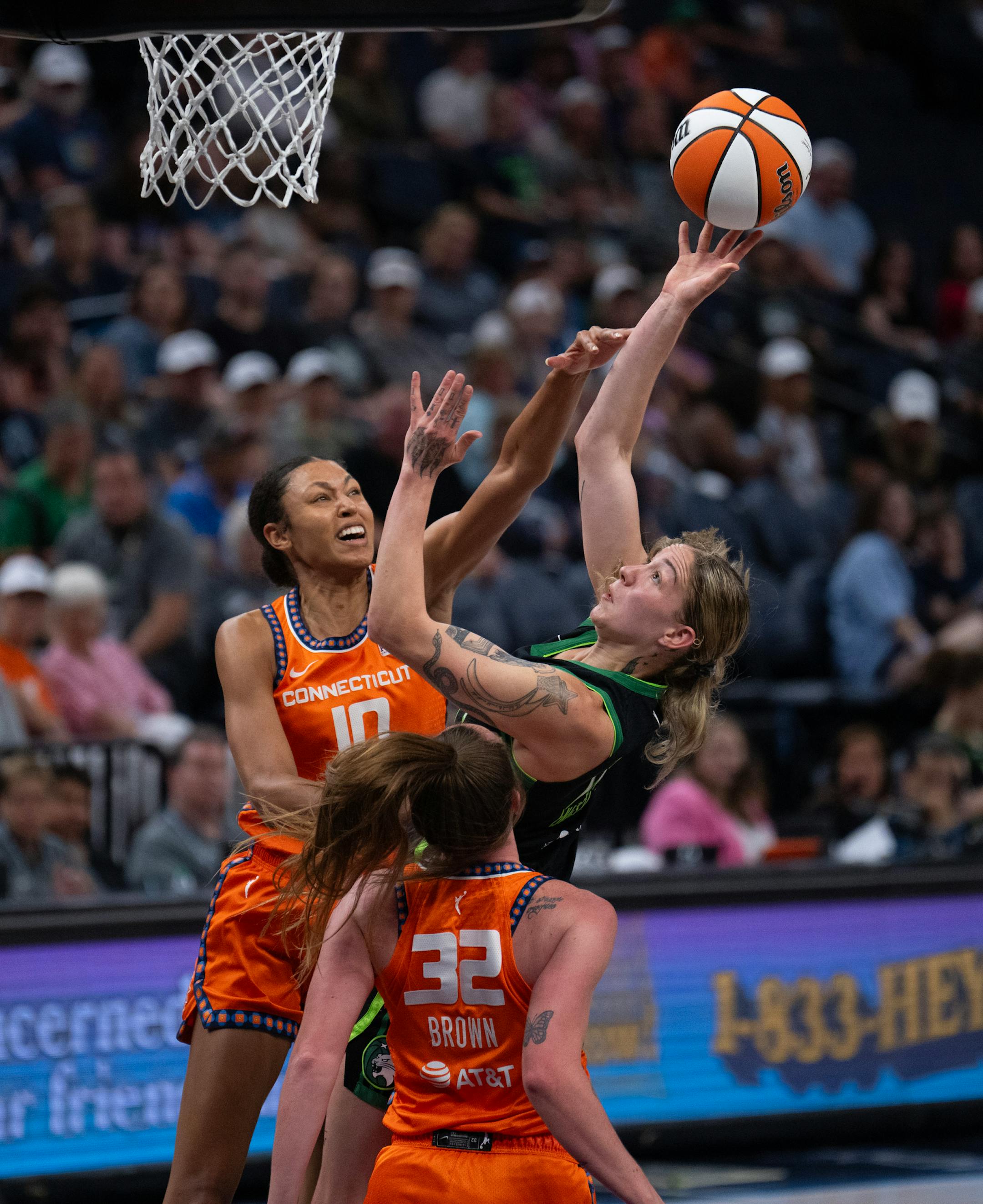 Lynx forward Emily Engstler shot around the defense of Connecticut Sun forward Olivia Nelson-Ododa (10) and Sun guard Leigha Brown (32) in the fourth quarter Thursday night. The Minnesota Lynx lost to the Connecticut Sun 89-68 in a WNBA game Thursday night, June 22, 2023 at Target Center in Minneapolis.