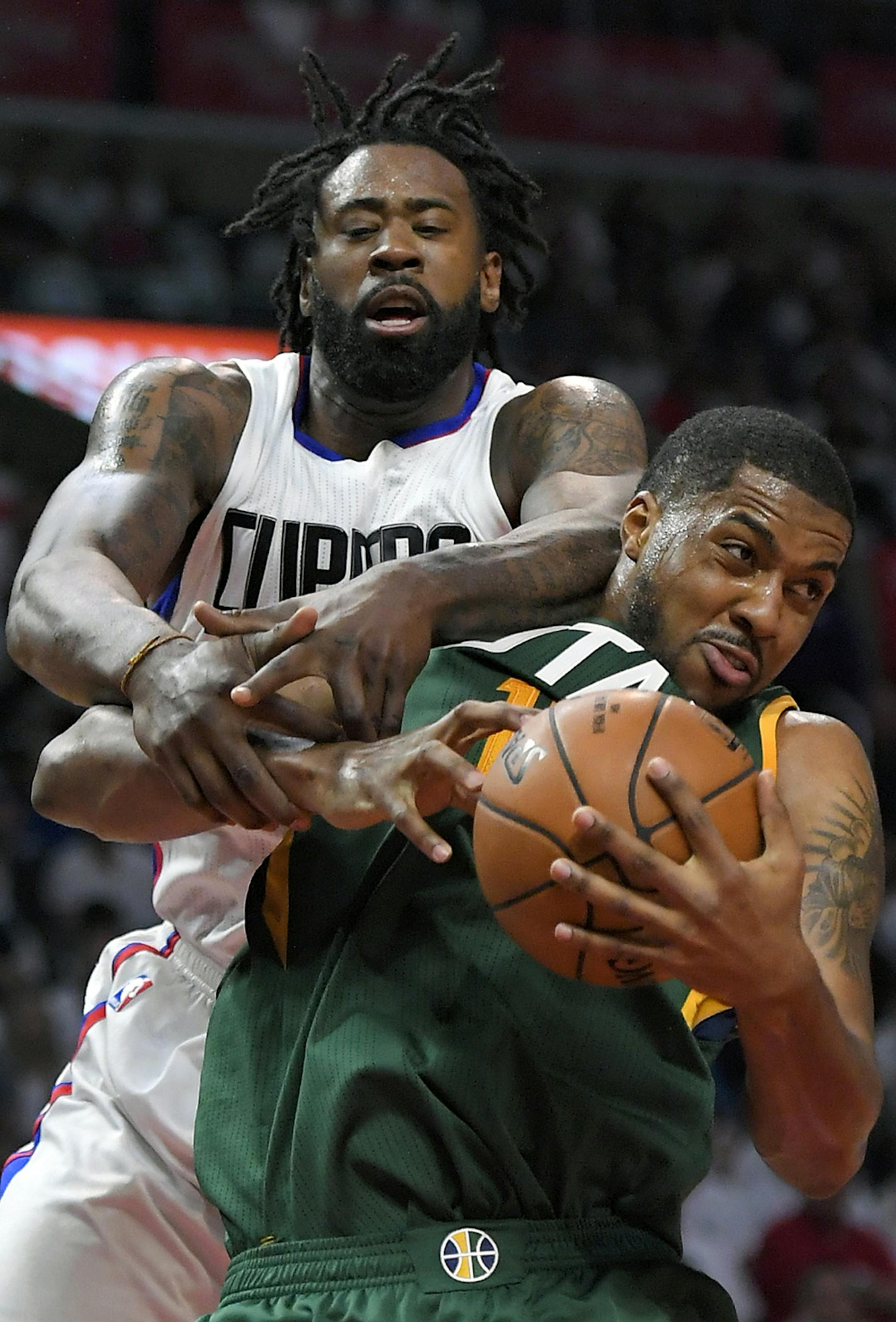 Los Angeles Clippers center DeAndre Jordan, top, and Utah Jazz forward Derrick Favors go after a rebound during the second half in Game 7 of an NBA basketball first-round playoff series, Sunday, April 30, 2017, in Los Angeles. (AP Photo/Mark J. Terrill)