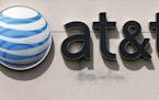 FILE In this May 14, 2014 file photo, an AT&T logo is seen on a store in Dedham, Mass. In a big win for the Obama administration, a federal appeals co