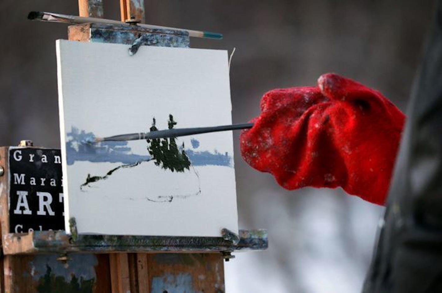 Neil Sherman uses a modified chopper mitt so he can paint in extreme cold.