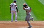 Minnesota Twins' Jake Cave, right, rounds the bases after hitting a grand slam as Chicago White Sox second baseman Leury Garcia looks down during the 