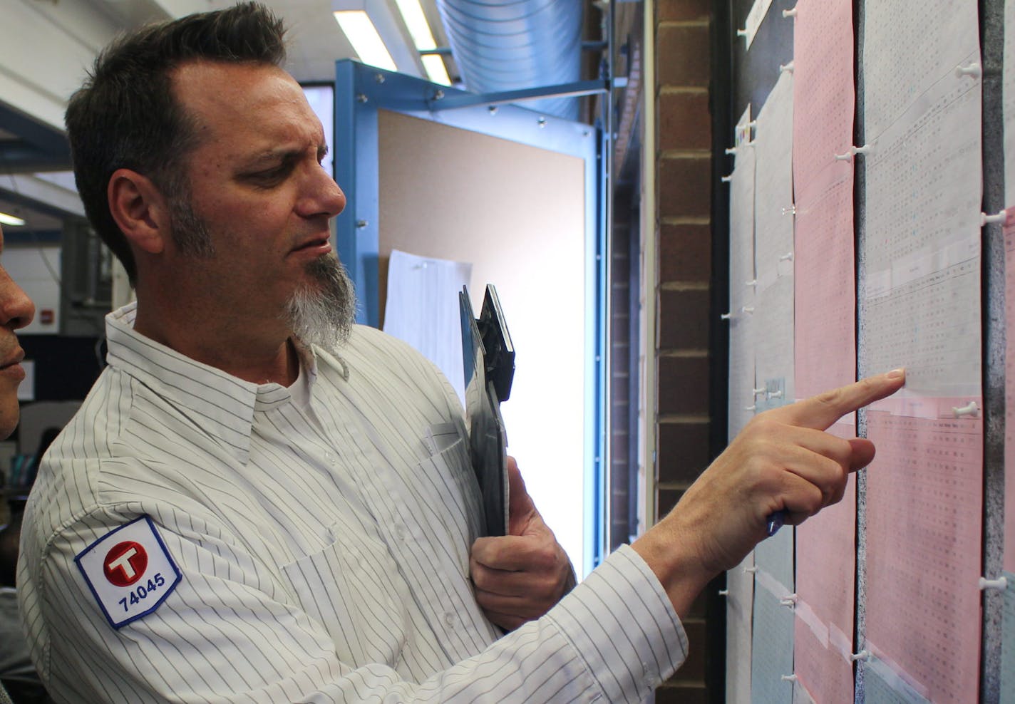 Larry Klimek (right), a Metro Transit bus operator, assists his mentee Angel Rodriguez with route options at Heywood Garage.