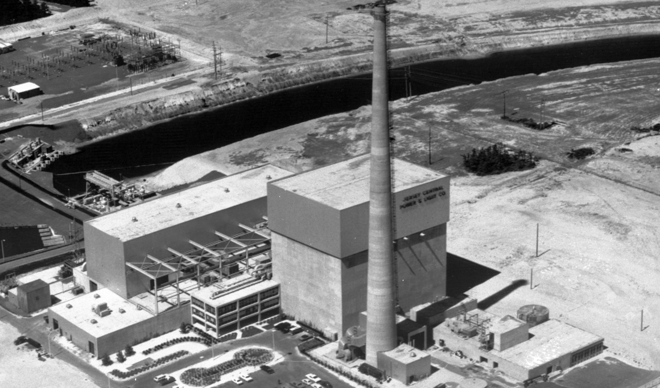 FILE - This July 12, 1972 file photo shows the Oyster Creek nuclear power plant in Lacey Township, N.J. Federal regulators say America’s oldest nuclear power plant will shut down Sept. 17, 2018, and plans to have its reactor fuel placed into dry storage within about six years. But the Oyster Creek plant, which opened in 1969, will remain in Lacey Township, New Jersey, until nearly the end of this century. (AP Photo, File)