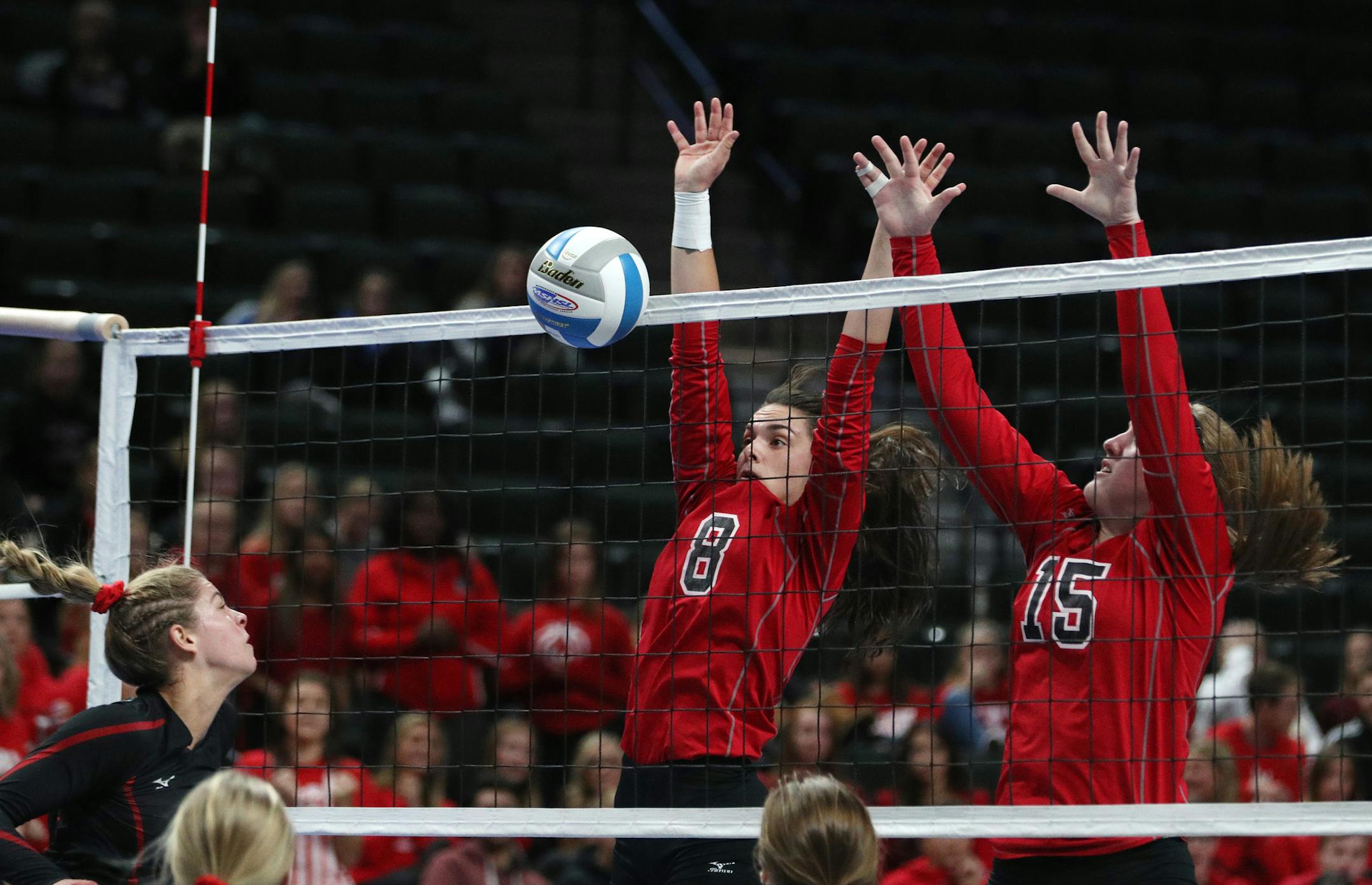 Stillwater Area High School's Mikayla Gjerde (2) sent the ball over the net as Lakeville North High School's Arianna Barrett (8) and Kennedy Brady (15) leapt to defend. ] ANTHONY SOUFFLE ï anthony.souffle@startribune.com Game action from a Class 3A volleyball quarterfinal volleyball match between Lakeville North High School and Stillwater Area High School Thursday, Nov. 9, 2017 at the Xcel Energy Center in St. Paul, Minn.