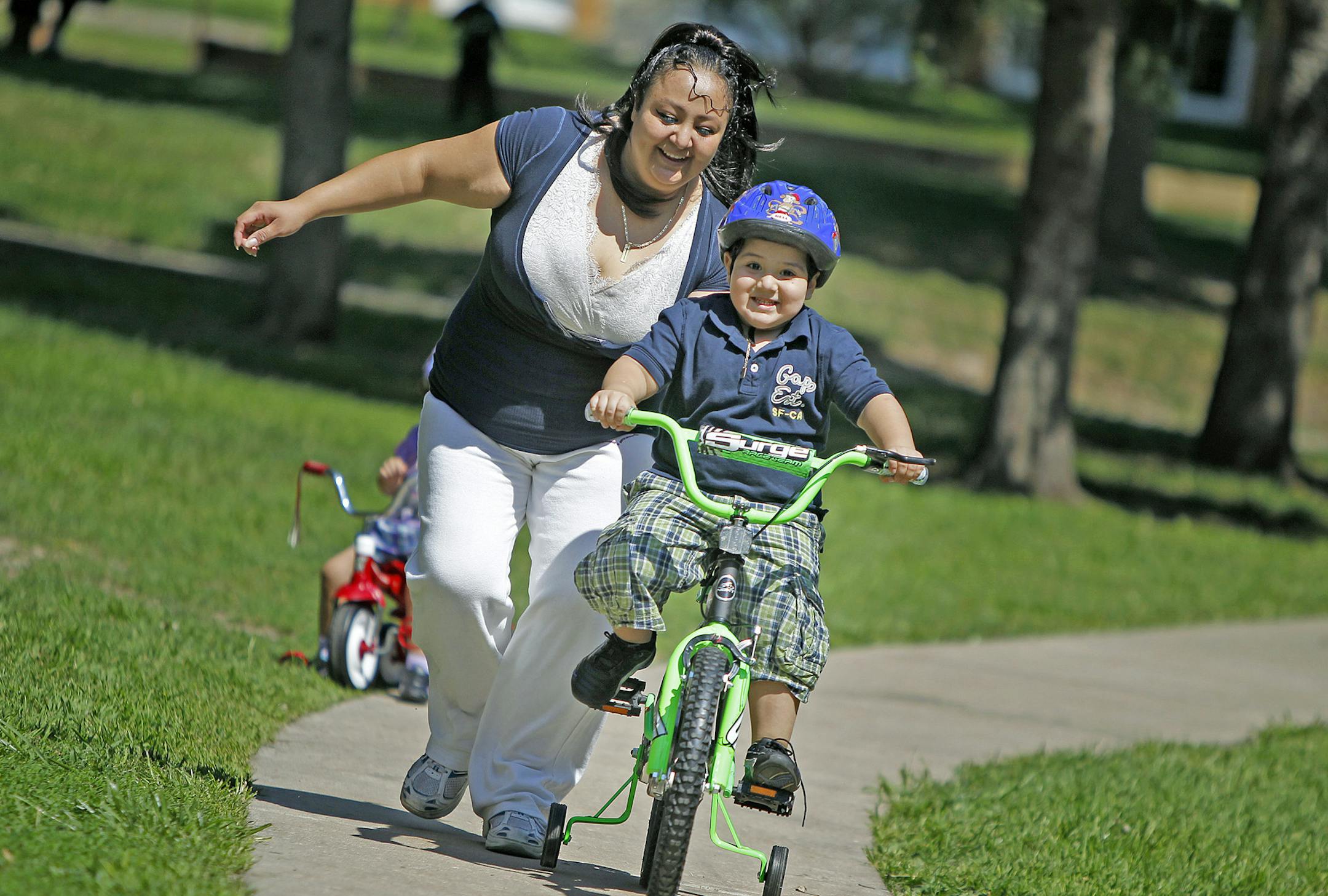 Christina Diaz took her 4-year-old son Christian Prado-Diaz and daughter Megan, 2, for a bike ride near their home, Friday, August 16, 2013 in Richfield, MN. A slight decline in childhood obesity among low-income families in Minnesota might just have to do with programs like Vida Sana and the resolve of mothers such as Christina Diaz. When the Richfield woman learned her four-year-old was obese, Diaz eliminated bad foods from her home, bought her son a bicycle to ride and enrolled the famiiy in