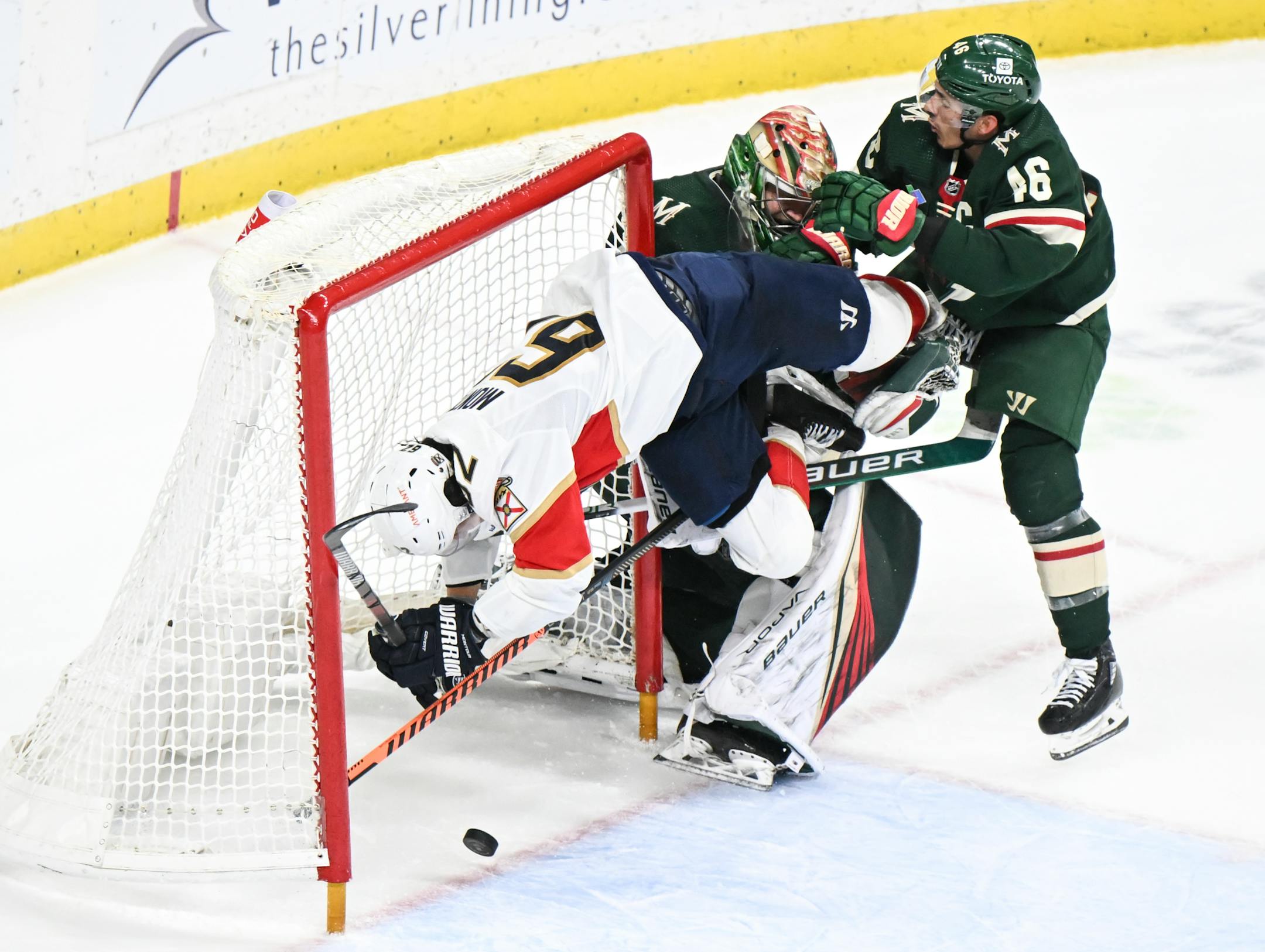 Florida Panthers defenseman Brandon Montour (62) crashes into Minnesota Wild goaltender Filip Gustavsson (32) with defenseman Jared Spurgeon (46) in pursuit as time expired during overtime.