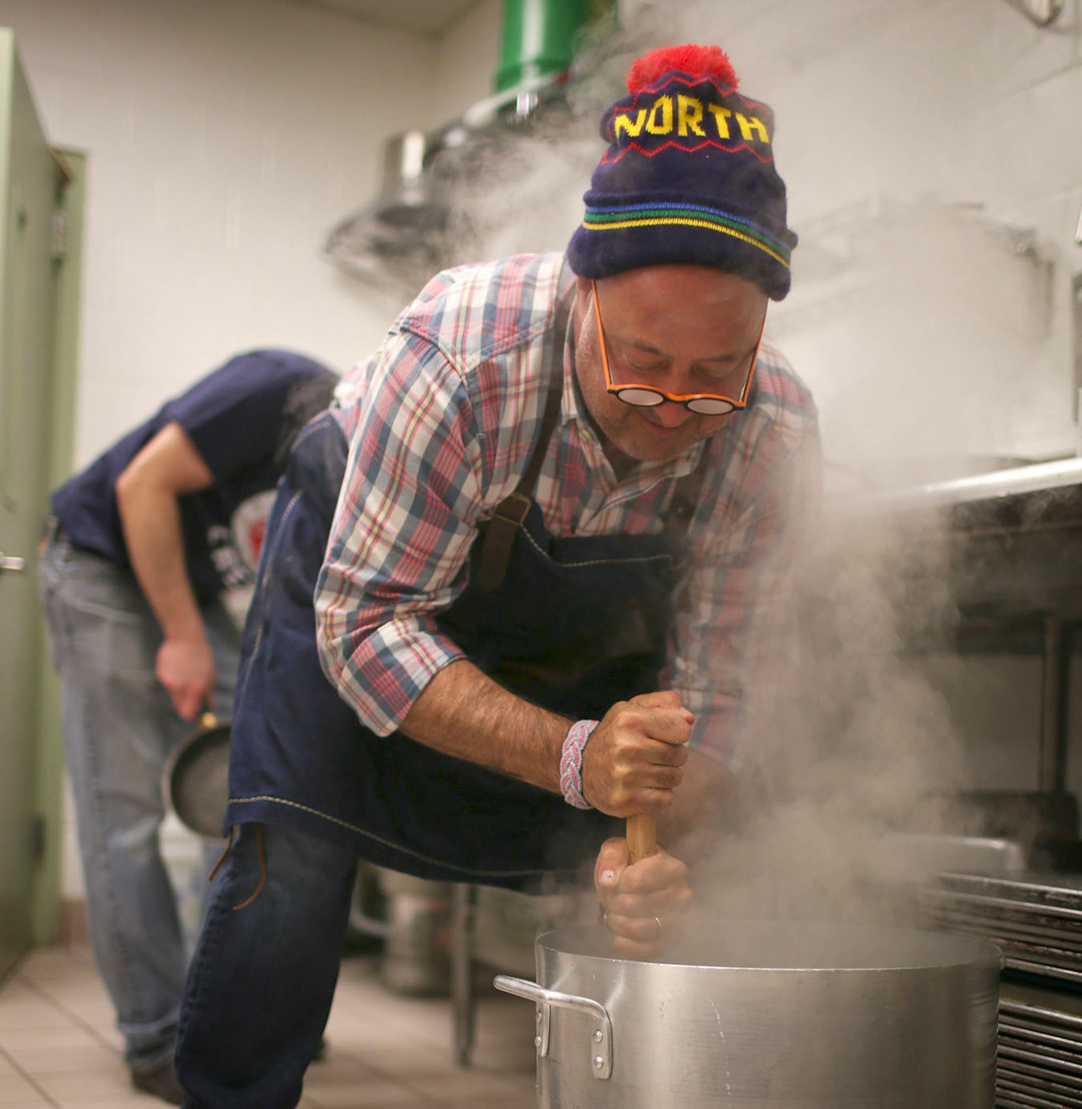 Travel Channel host (and Twin Cities resident) Andrew Zimmern stopped by the Salvation Army's Payne Ave. location in St. Paul to cook with chef Jeff Ansorge, former head chef at the Captal Grille in Minneapolis, as he prepared a meal Monday afternoon, March 3, 2014 for donors and volunteers. Andrew Zimmern dug in to mash a big batch of potatoes while working in the kitchen at the Eastside Corps. Community Center in St. Paul Monday afternoon. ] JEFF WHEELER ‚Ä¢ jeff.wheeler@startribune.com