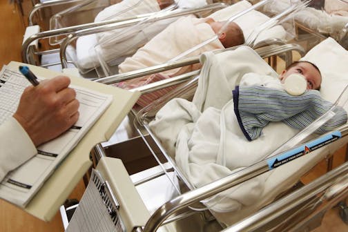 FILE - This Feb. 16, 2017 file photo shows newborn babies in the nursery of a postpartum recovery center in upstate New York. According to a government report released Wednesday, May 15, 2019, U.S. birth rates reached record lows for women in their teens and 20s, leading to the fewest babies in 32 years.