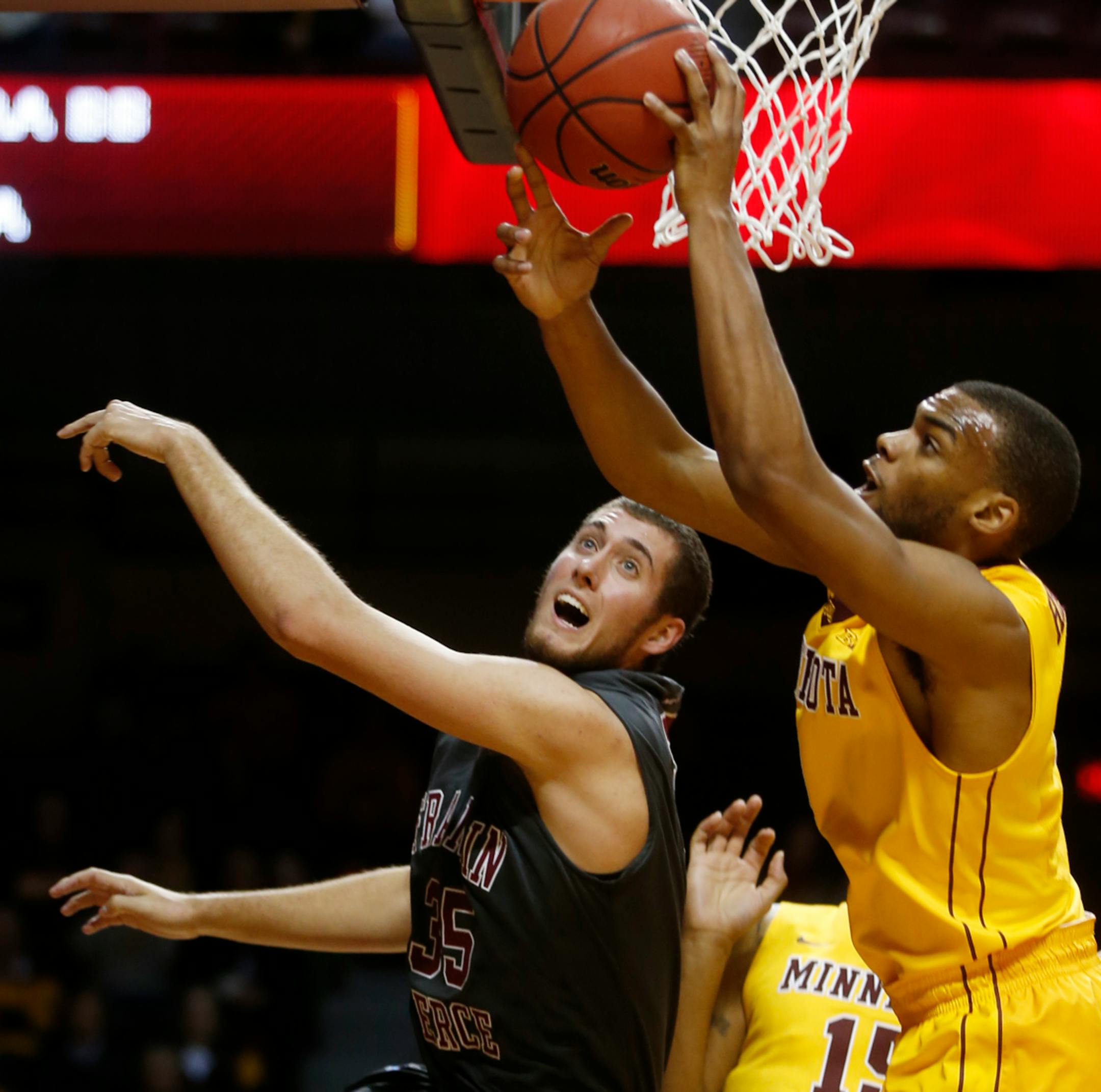 Mike McDevitt (35) fought the Gophers' Andre Hollins (1) for a rebound.