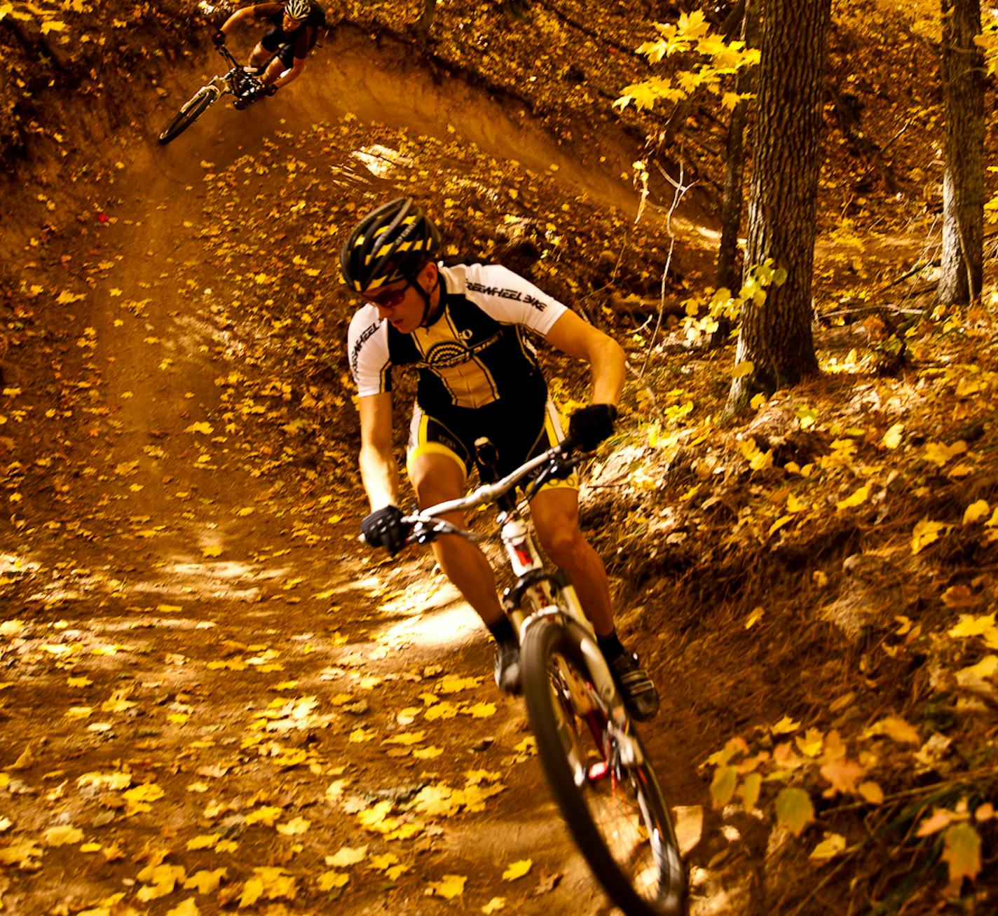 Photo by Hansi Johnson. Riders maneuver the "Gravity Cavity," a large gully offering roller-coaster-like rides along Wisconsin's Esker Trail.