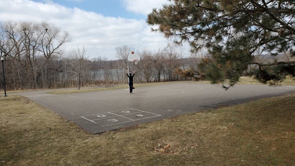 A young woman found a basketball hoop to herself at Theodore Wirth Park in Minneapolis on Monday.