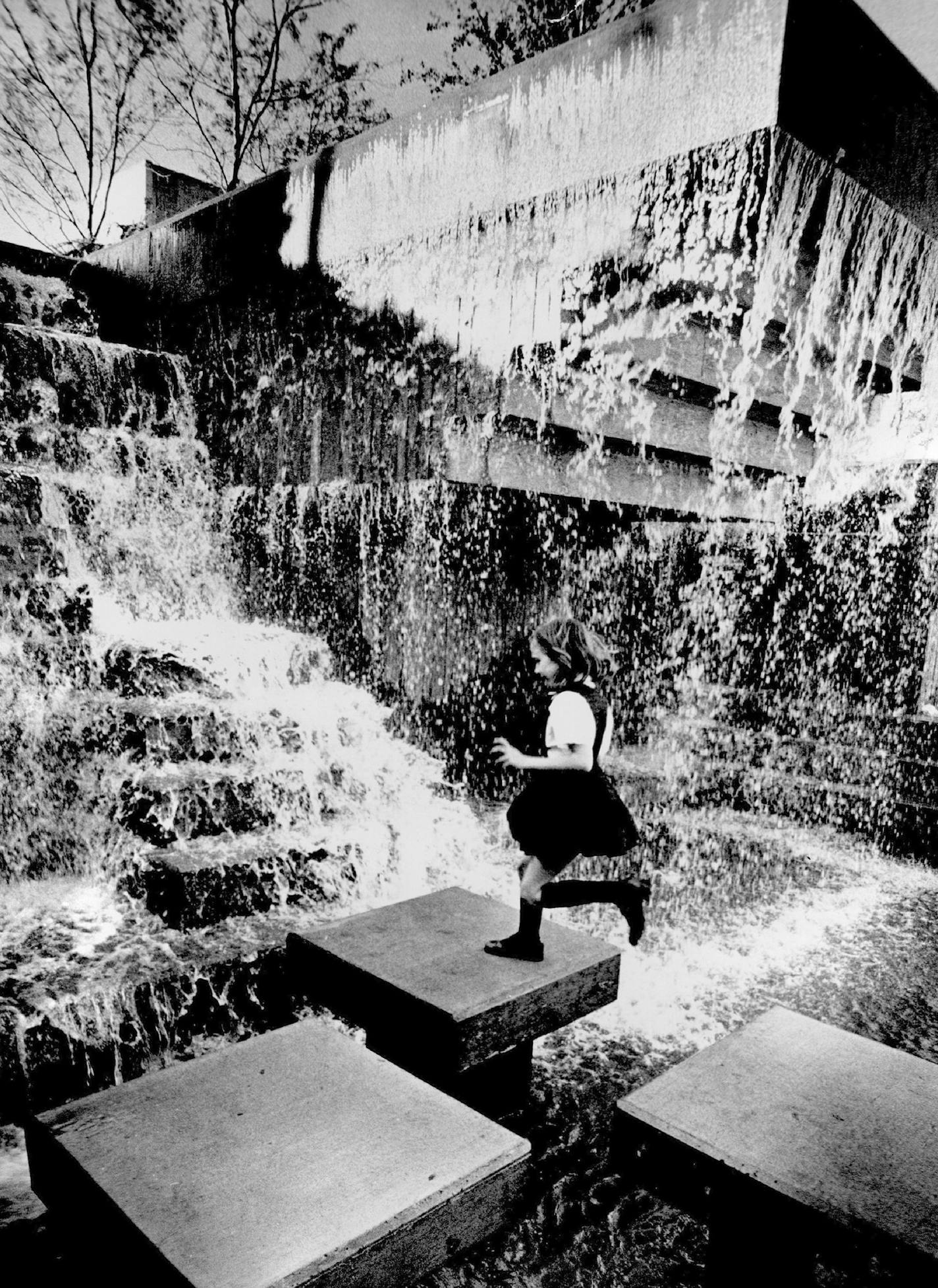 September 26, 1975 Enjoying the cascades Laura Jacobsen, 7, tried the artificial stepping-stones at the waertfall fountain in Peavey Park. All the fountains were splashing Thursday in the park, which is the mild early-fall weather. adjacent to Orchestra Hall, and strollers were enjoy ORG XMIT: MIN2014111011193654 ORG XMIT: MIN1411111537334011