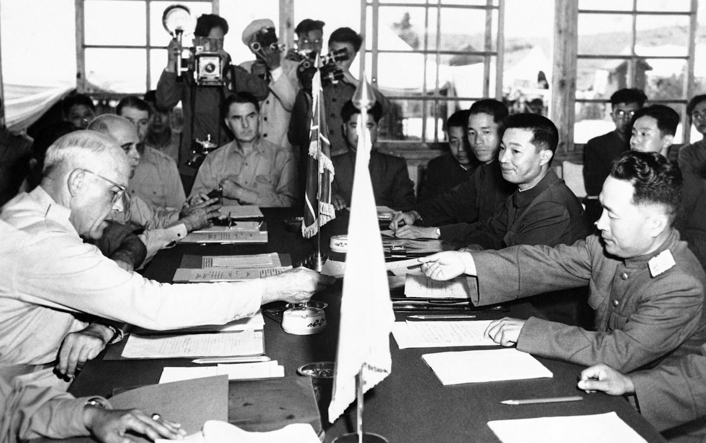 Major General Blackshear M. Bryan, left, exchanges credentials with North Korean Lt. General Lee Sang Cho at the opening session of the military armistice commission at the Panmunjom conference house July 28, 1953. At Lee&#xed;s right is Chinese General Ting Kuo JO and at Ting&#xed;s right, Chinese General Tsai Cheng Wen. Others unidentified. (AP Photo) ORG XMIT: APHS311340