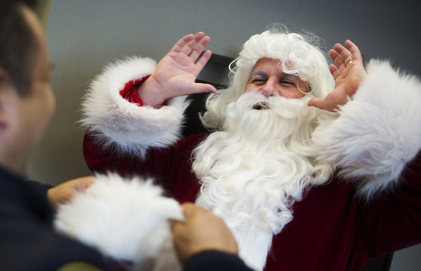 At Gillette Children's Specialty Healthcare, Sgt. Santa Claus a.k.a. Todd Feroni got ready to give out presents to kids he was visiting in various wards.] Richard Tsong-Taatarii/rtsong-taatarii@startribune.com