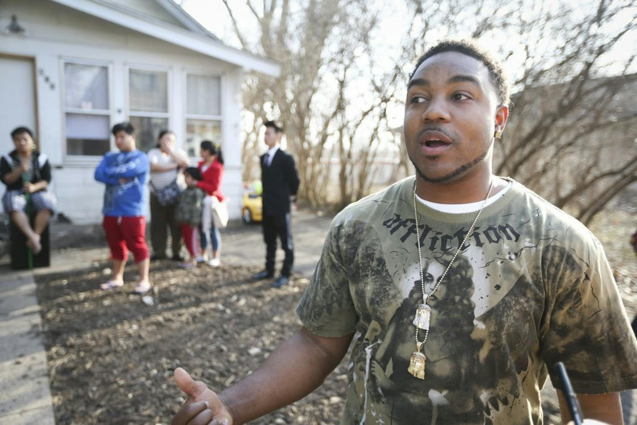 Donnell Gibson, left, pulled over and rushed into a house he noticed was on fire when he saw three bewildered children on the front stoop. Then Gibson rallied the other members in the house to leave. He was photographed at the scene in St. Paul, Minn., on Wednesday, April 1, 2015.
