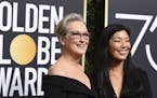Meryl Streep, left, and Ai-jen Poo arrive at the 75th annual Golden Globe Awards at the Beverly Hilton Hotel on Sunday, Jan. 7, 2018, in Beverly Hills