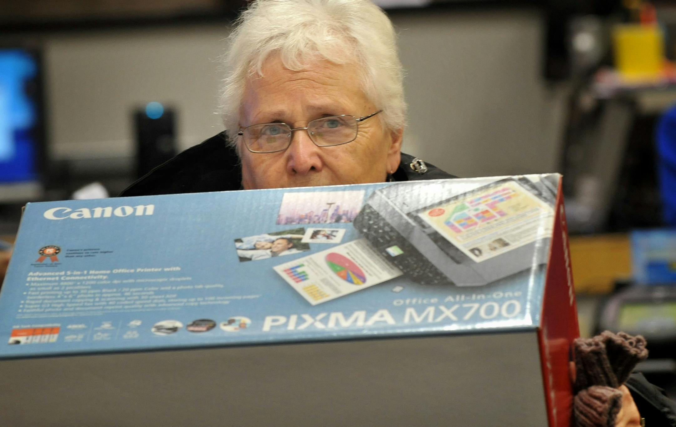 5:09 a.m. -- Ruth Wachter carried her new Canon printer out of the Apple Valley Best Buy after waiting outside Friday morning.